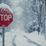 Stop sign colored red during snowy winter weather